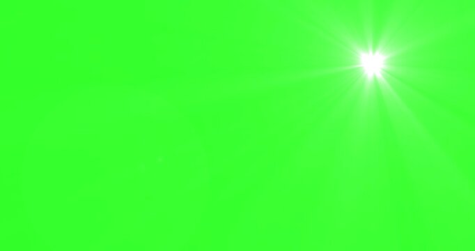 sun shining light optical lens flare effect with rotating sunlight rays on green background Chroma Key. Bright white lens flare effect with radiating light beams
