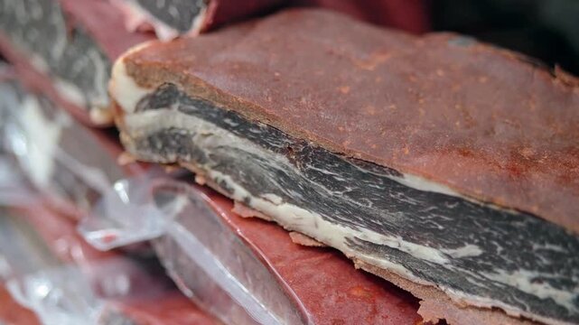 Slabs of spiced cured beef stacked in vacuum packaging