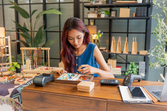 Asian business owner qc all handcrafted jelvery in store