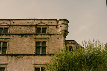 Old castle facade with turret and greenery © Marius Indrei Photos