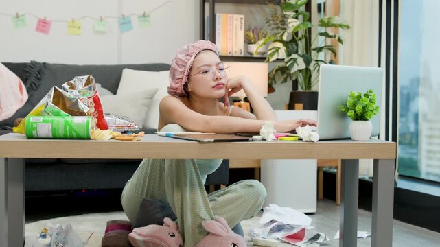 Bored Asian Woman in Shower Cap Procrastinating in Messy Living Room