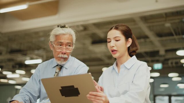 Young woman gesturing while thoughtful senior Thai man looks away