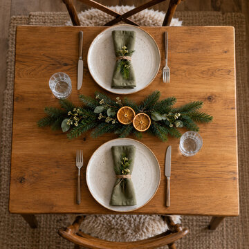 Two simple festive place settings on a small dining table