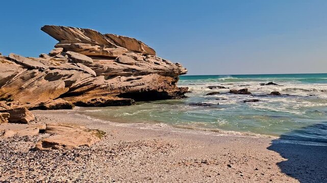Beach cove with interesting rock formations and waves roll onto the sand