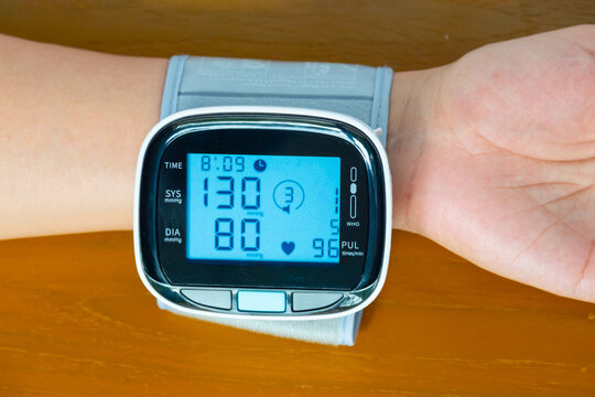 Man check blood pressure monitor and heart rate monitor with digital pressure gauge. Health care and Medical concept	
