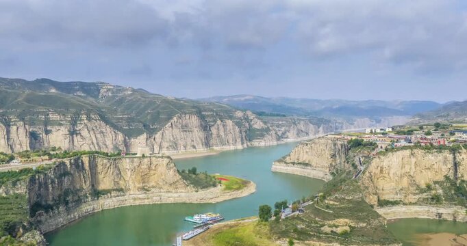 Aerial time-lapse ancient watchtower on cliff above Yellow River bend, Laoniuwan village, Pianguan county, Shanxi province, China
