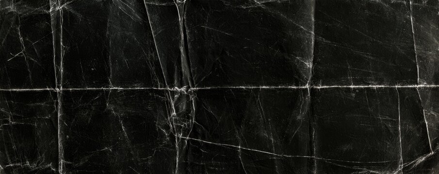 Black marble surface with white veins and natural cracks forming an elegant and textured pattern.