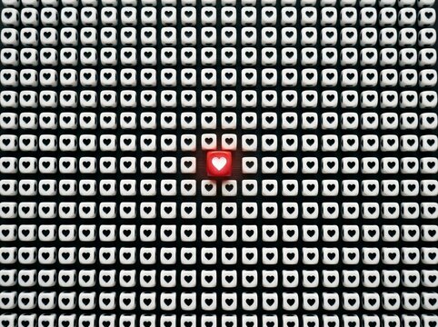 Heart Bead Glowing Red Standing Out in a Pattern of White Cubes