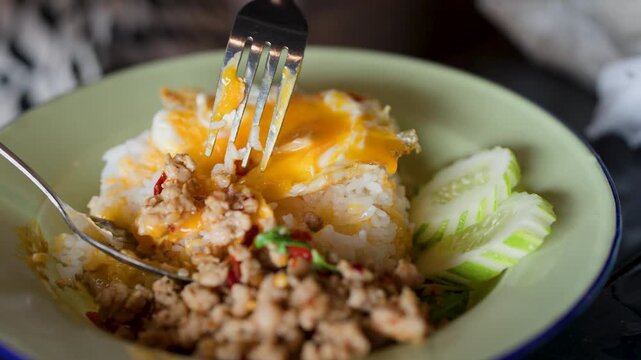 Eating Pad Krapow Minced Pork with Fried Egg and Rice