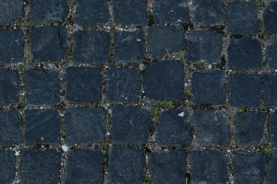 texture of grey, rough, paving stones road