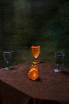Four plastic glasses on the table against a green background.