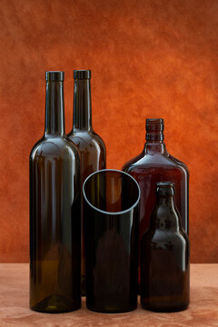 Still life with glass objects against a brown background