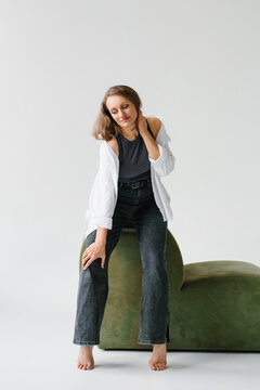 Woman Sitting Green Velvet Sofa Studio Portrait