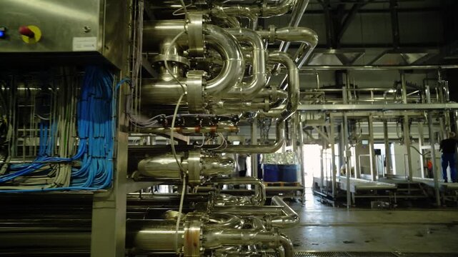 Stainless steel pipes and valves in industrial dairy processing plant