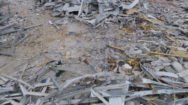 Drone view gliding low over twisted metal siding and concrete rubble from the demolished ATT Field, former home of the Chattanooga Lookouts baseball team in Tennessee.