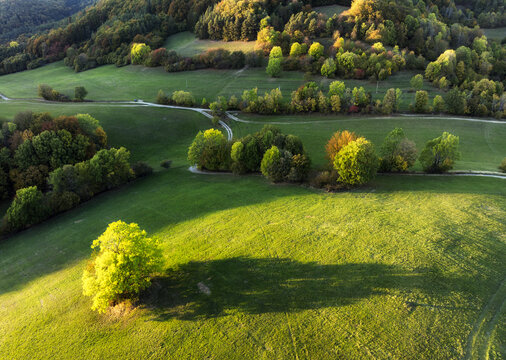 Scenic aerial view of a winding mountain by autumn forest colours and small village in Slovakia