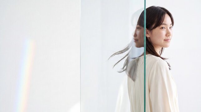 Minimal portrait of woman reflected in glass with soft rainbow light for clean background and lifestyle banner design