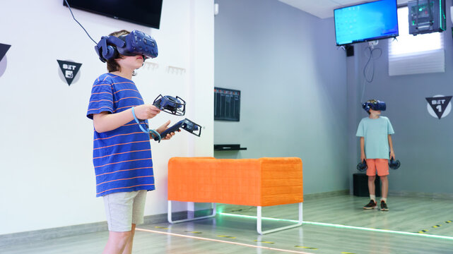 Kids playing virtual reality games with vr headsets