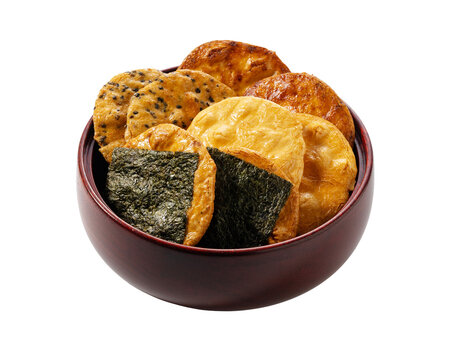 Assortment of traditional Japanese rice crackers senbei served in a wooden bowl isolated on transparent background