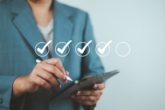 Businessman evaluating with checkboxes online on virtual screen. assessment survey online, choose correct answer in test, questions test, online exam, quiz knowledge, filling out an survey form.