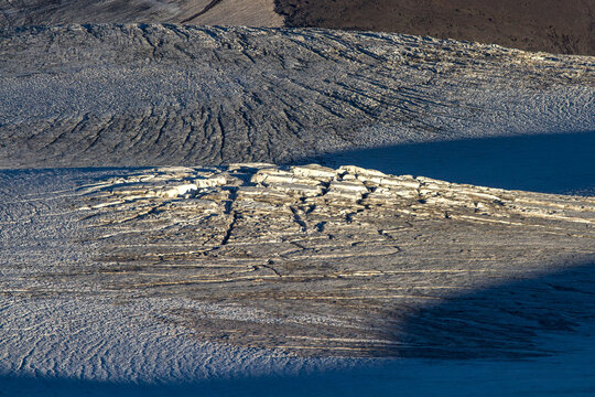Sun and shadows on a cracked glacier surface