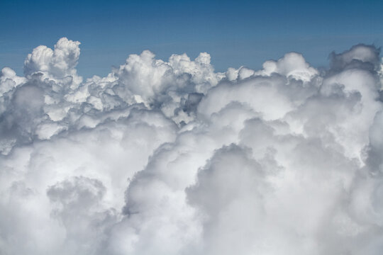 A stunning aerial view above thick white clouds