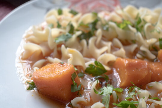 Tomato soup with pasta and parsley &ndash; a warm, homemade meal.
