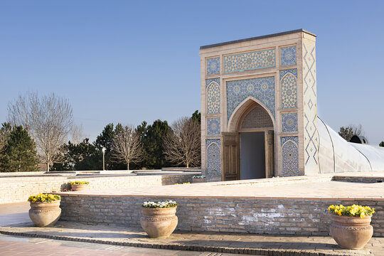Entrance portal of Ulugbek Observatory in Samarkand featuring ornate Islamic tilework and pointed arch. Historic astronomical landmark in Uzbekistan ideal for travel guides, cultural publication.