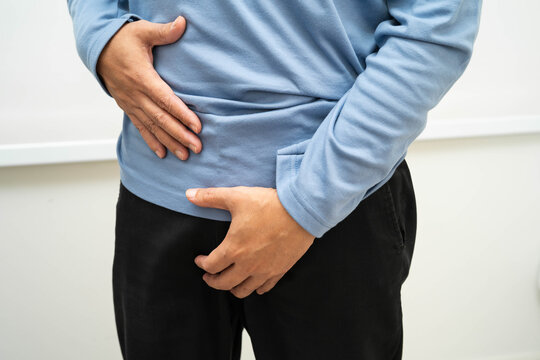 Hernia, Asian man stomach ache, abdominal pain and urology problem health.