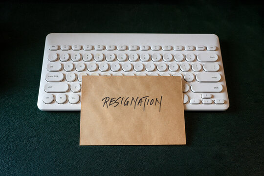 Resignation letter on top of keyboard. Top view.