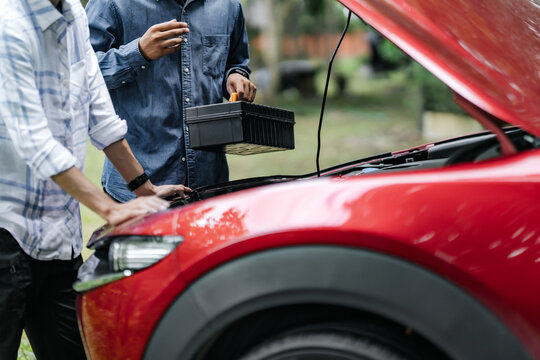 Repair service auto mechanic working on car engine at outdoor, roadside assistance