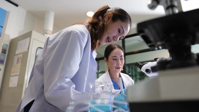 Young female scientist conducting experiment in laboratory.