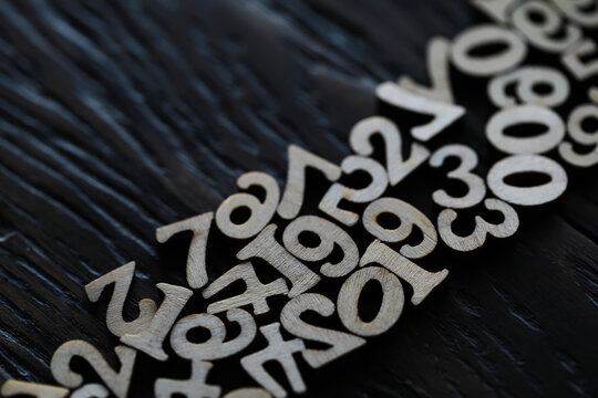 Close-up of Wooden Numbers on Dark Wood Background - Education, Mathematics, Counting, Numbers, Abstract, Minimalist