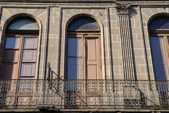 Historic Architecture with Arched Windows and Ornate Iron Balcony