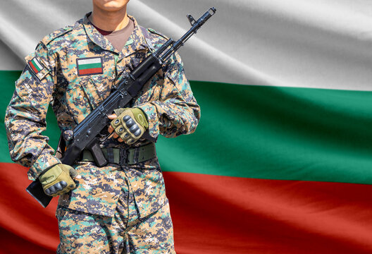 Bulgaria flag with soldier in military uniform holding assault rifle in front of it