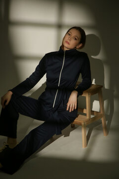 Stylish Female Model Wearing a Navy Blue Cotton Co-Ord Set in Dramatic Studio Lighting, Elegant Fashion Editorial with Strong Shadows and Light Contrast