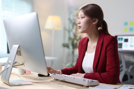 Professional woman working on computer in modern office.