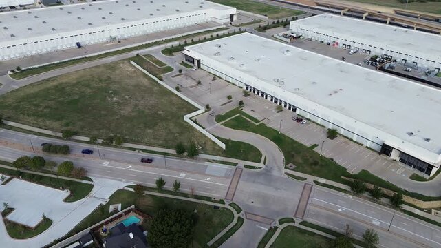 Central distribution architecture borders cargo hauling lanes along Northeast Loop. Symmetrical service ramps surround landscaped grass medians, trailer yards, access lanes, Haltom City, Texas