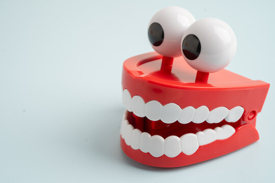 Funny red teeth with eye toy denture model for dental health care.
