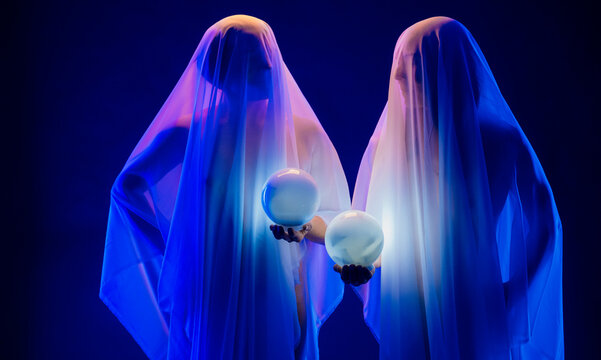 Ghost figures holding glowing crystal balls with blue lighting