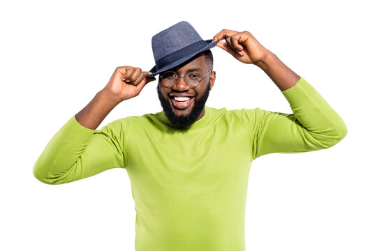 Portrait of candid person guy touching his cap laughing wearing green jumper isolated over white background