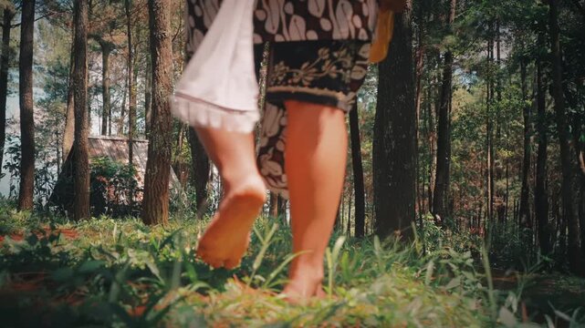 Bare Feet of a Javanese Dancer Walking on Forest Ground
