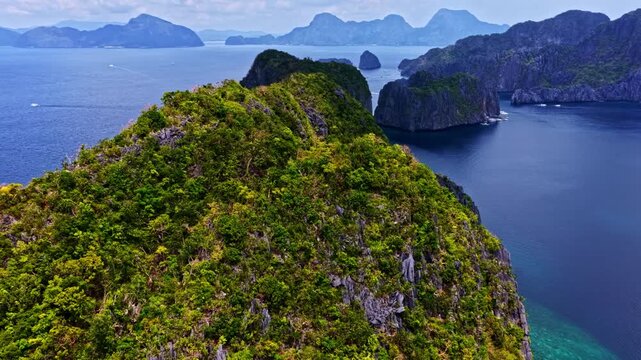 Aerial view of lush green karst islands surrounded by deep blue tropical waters in Mimaropa, Philippines.