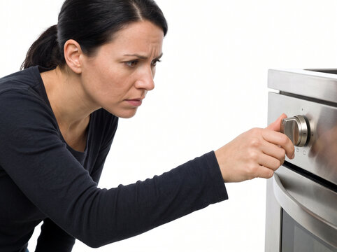 Woman struggling with obsessive-compulsive disorder checking stove knob repeatedly at home to relieve persistent anxiety and stress
