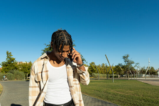 Man talking on phone enjoying urban park outdoors