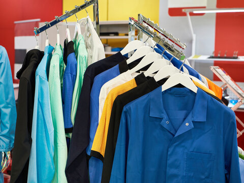 Colorful Industrial Workwear and Protective Clothing Hanging on Display Racks