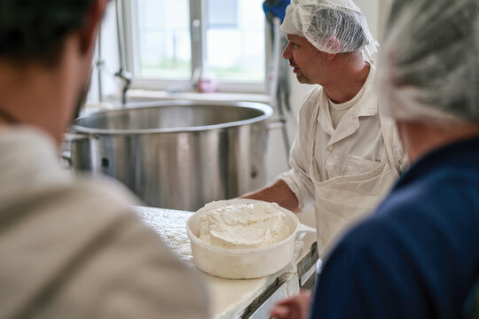 A baker discusses the vital role of flour in the production of baked goods, showcasing the intricate process and collaborative efforts in a bustling bakery environment.