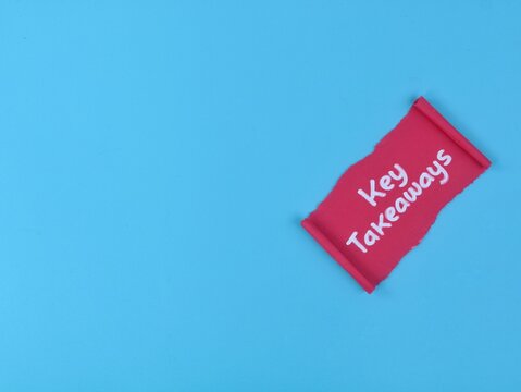 Key takeaways concept handwritten on a torn red paper note on blue background. Ideal for business summaries, educational highlights, main points, learning conclusions, and presentations