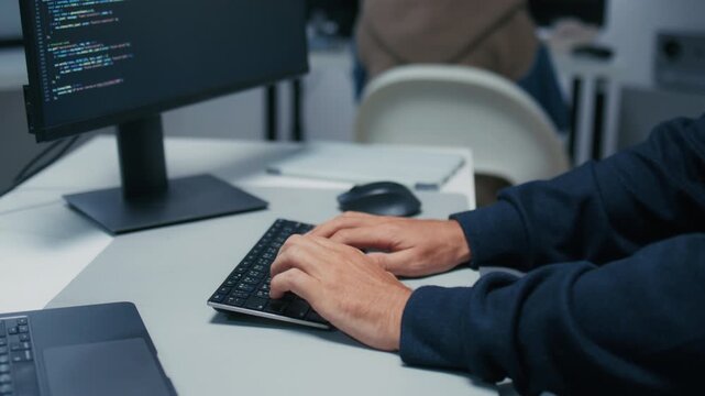 Close Up of Male Software Developer Typing on Computer Keyboard While Writing Programming Code in Modern Technology Office. Male Programmer Working on Software Development Project.