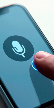 Smartphone screen with microphone icon and finger activating voice assistant, mobile voice control and speech recognition technology concept